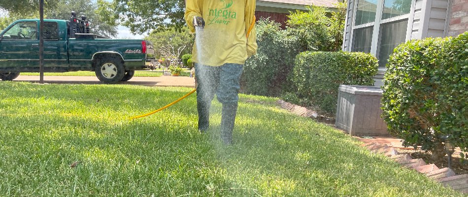 Integra Worker Spraying Lawn With Pest Control Treatment